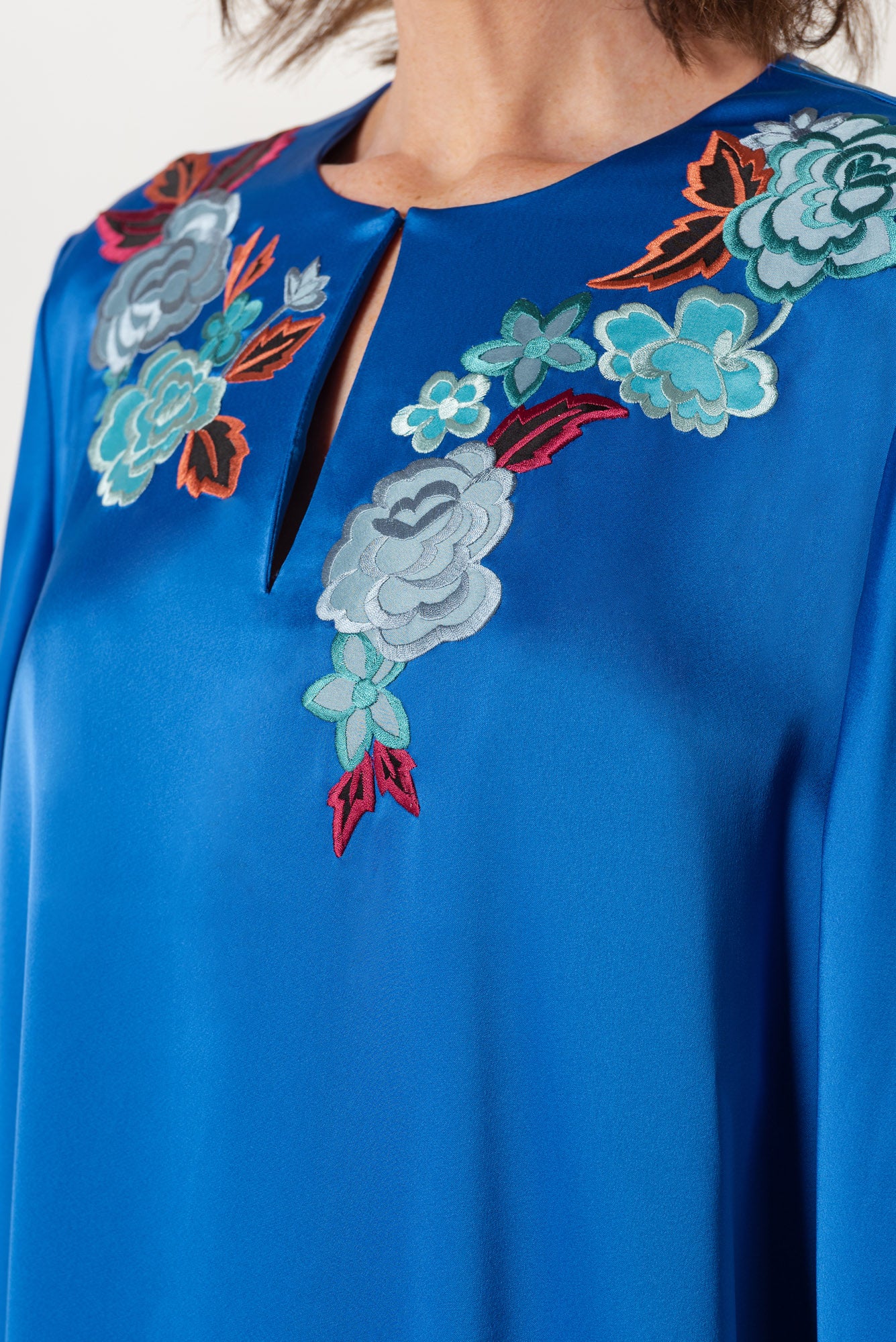Blue evening dress with floral embroidery on neck