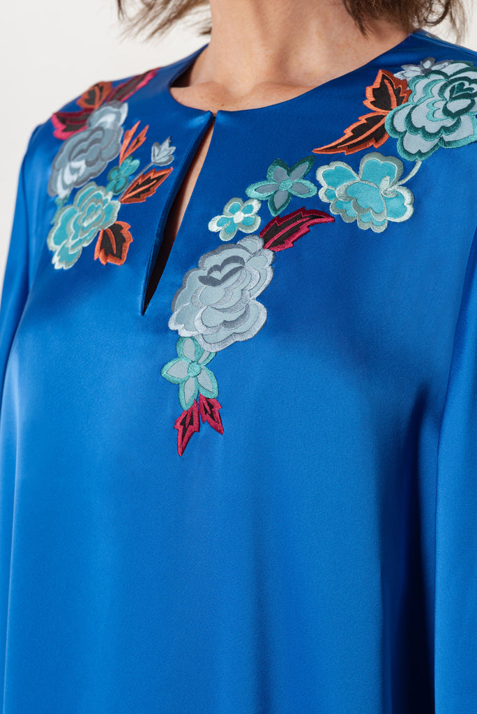 Blue evening dress with floral embroidery on neck